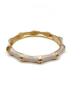 Gold and beige bangle on a white background