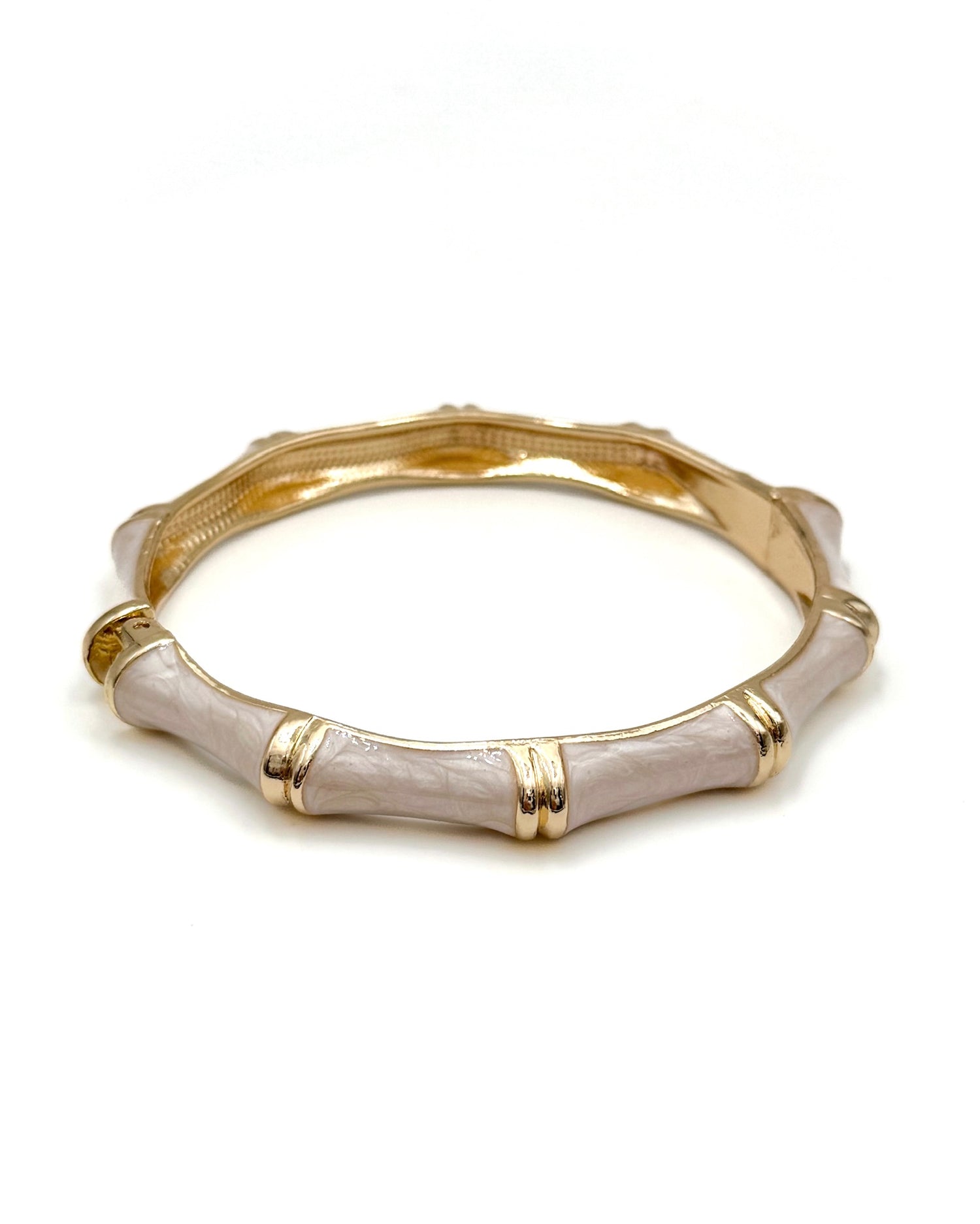 Gold and beige bangle on a white background