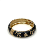 Wide enamel bangle with gold floral detailing and hinge clasp"