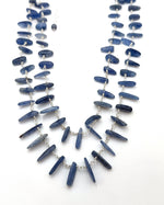Blue beaded necklace on a white background