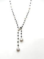 Necklace with black and white beads on a white background