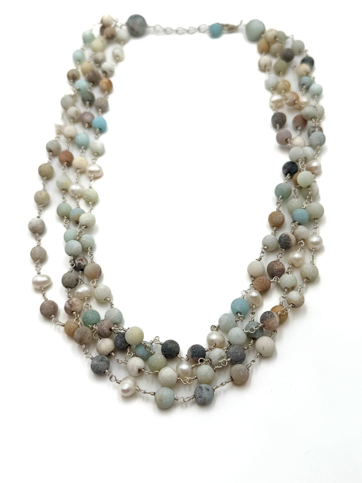 Multistrand necklace with multicolored beads on a white background