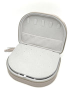 Victoria Curved Jewelry Case with the lift-up earring panel open, revealing hidden necklace storage and soft interior pockets.