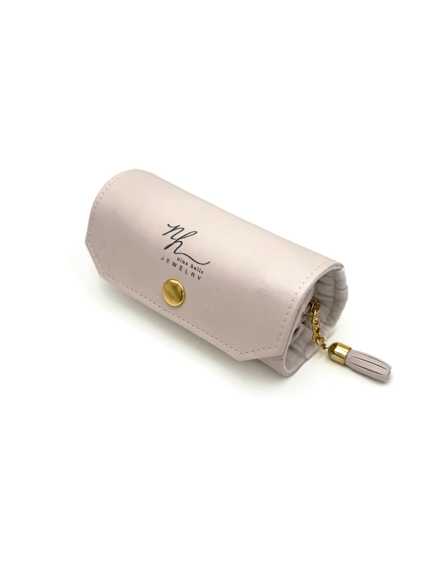Closed pink Nina Halls jewelry roll-up case with gold hardware and tassel zipper.
