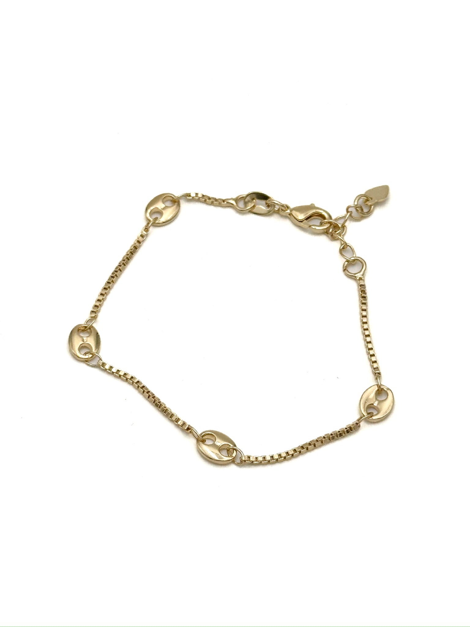 Lucia gold-tone oval link bracelet with slim chain and spaced oval links displayed on a neutral background.