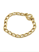 Lucie gold-tone elongated link chain bracelet with front toggle clasp displayed in a circle on a white background