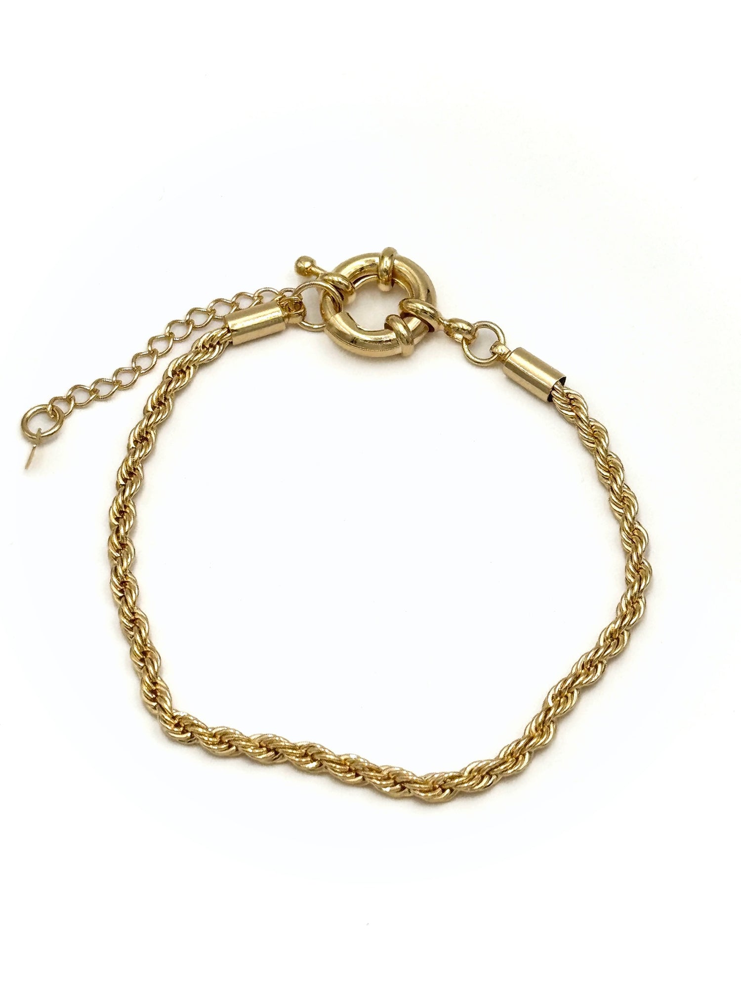 Colette gold-tone rope chain bracelet with bold front circle clasp and extender chain on a white background