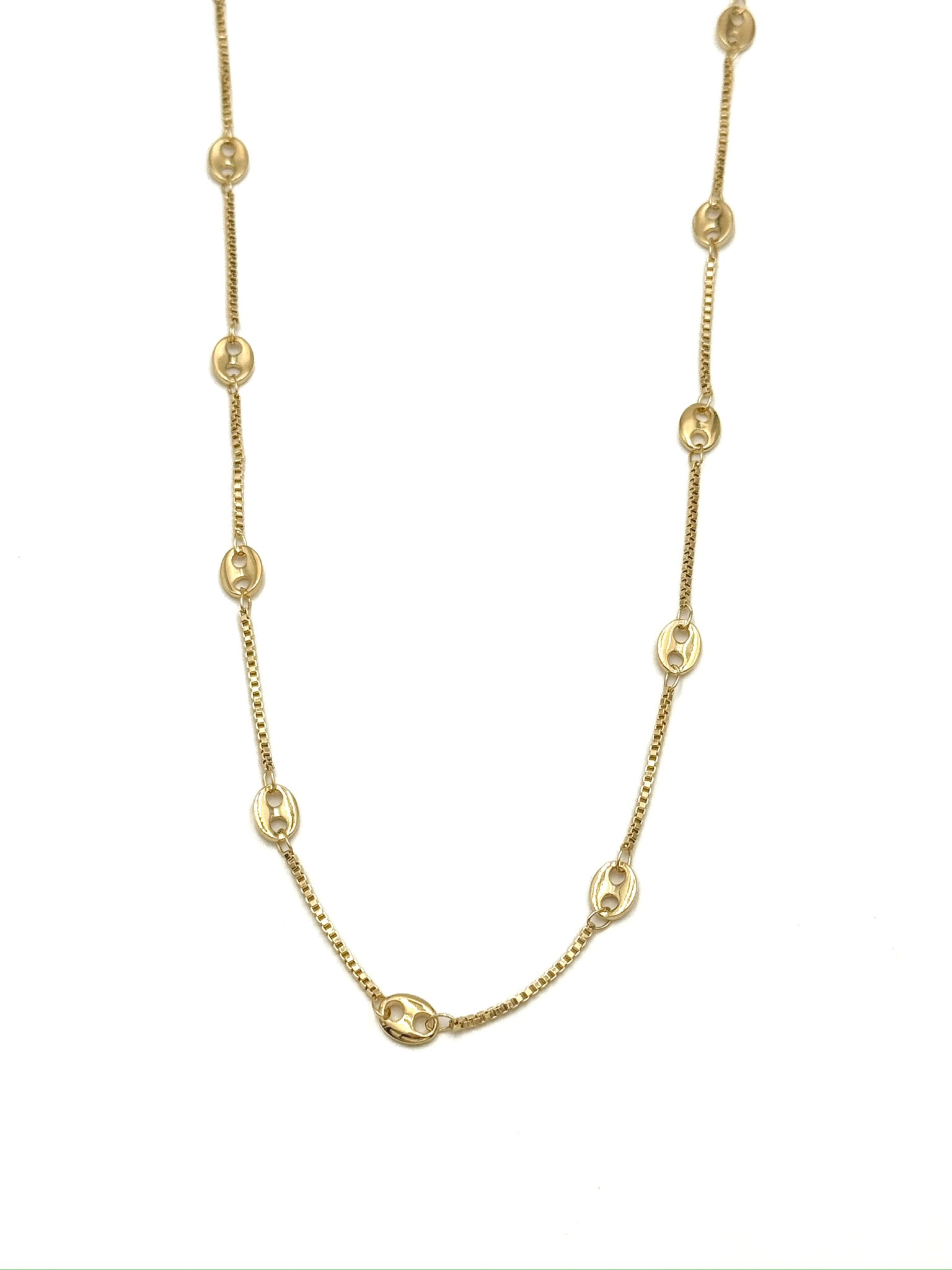 Gold chain necklace on a white background
