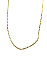 Gold chain necklace on a white background