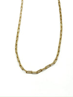 Gold chain necklace on a white background