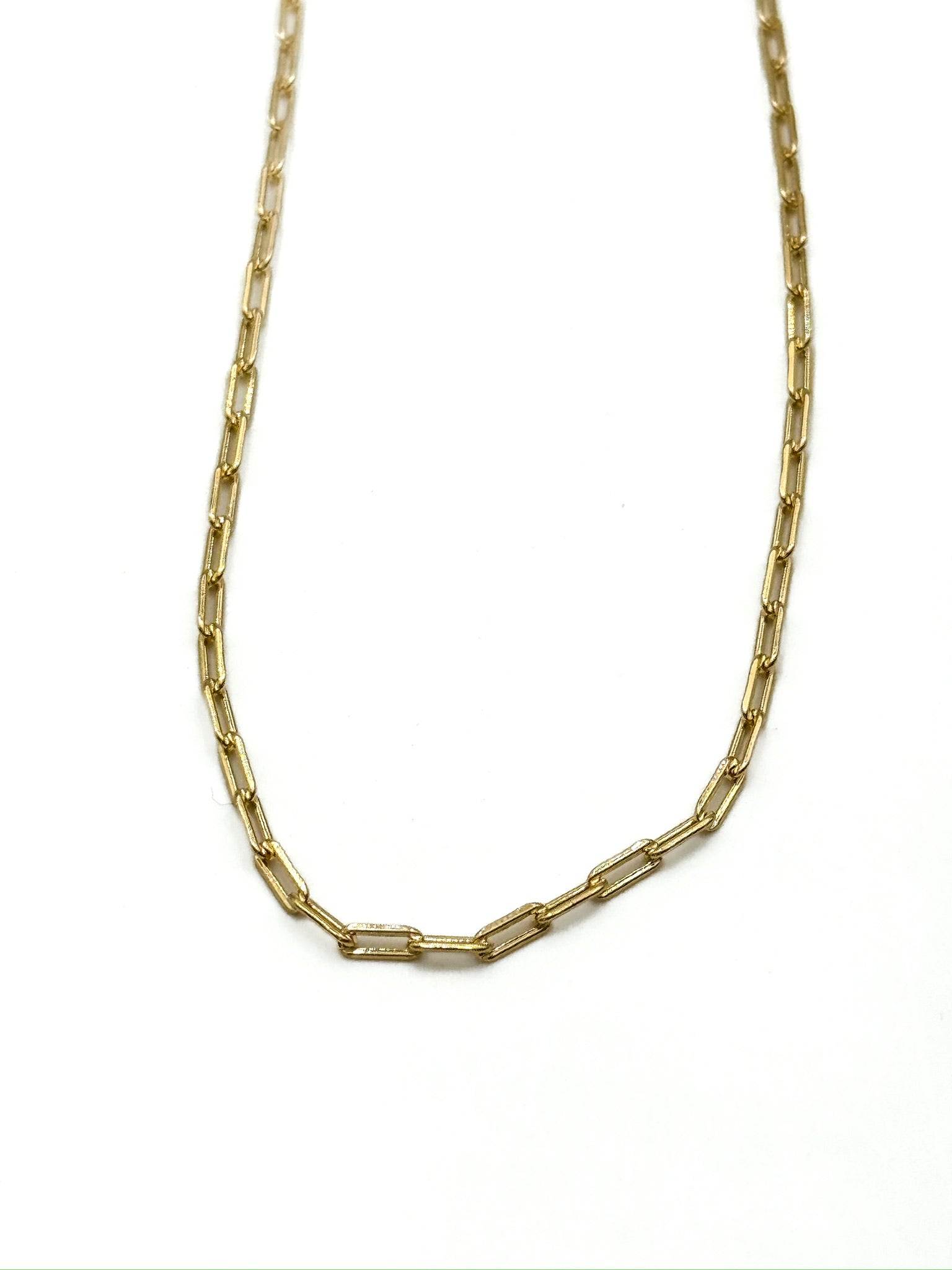 Gold chain necklace on a white background