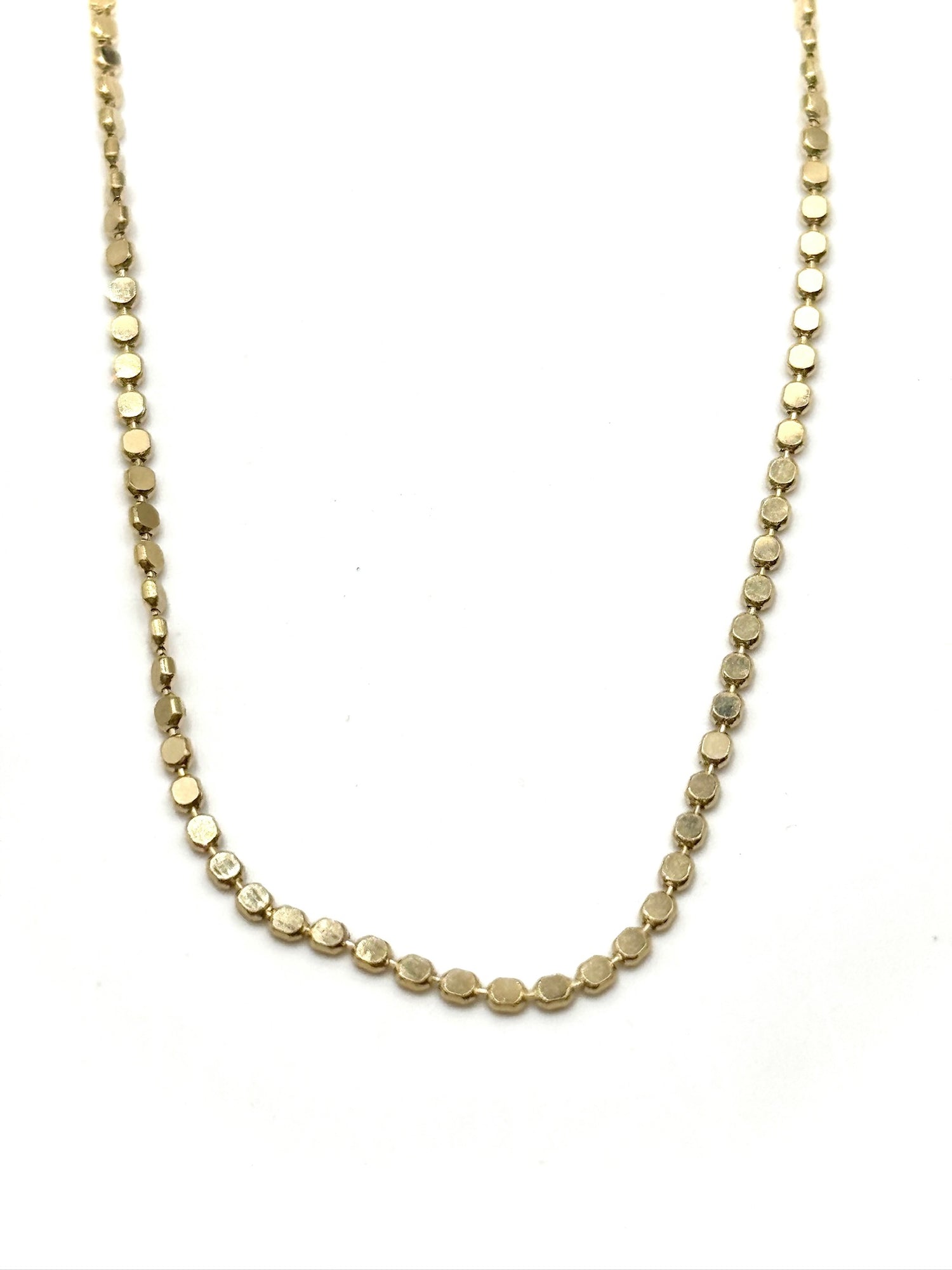 Gold necklace on a white background