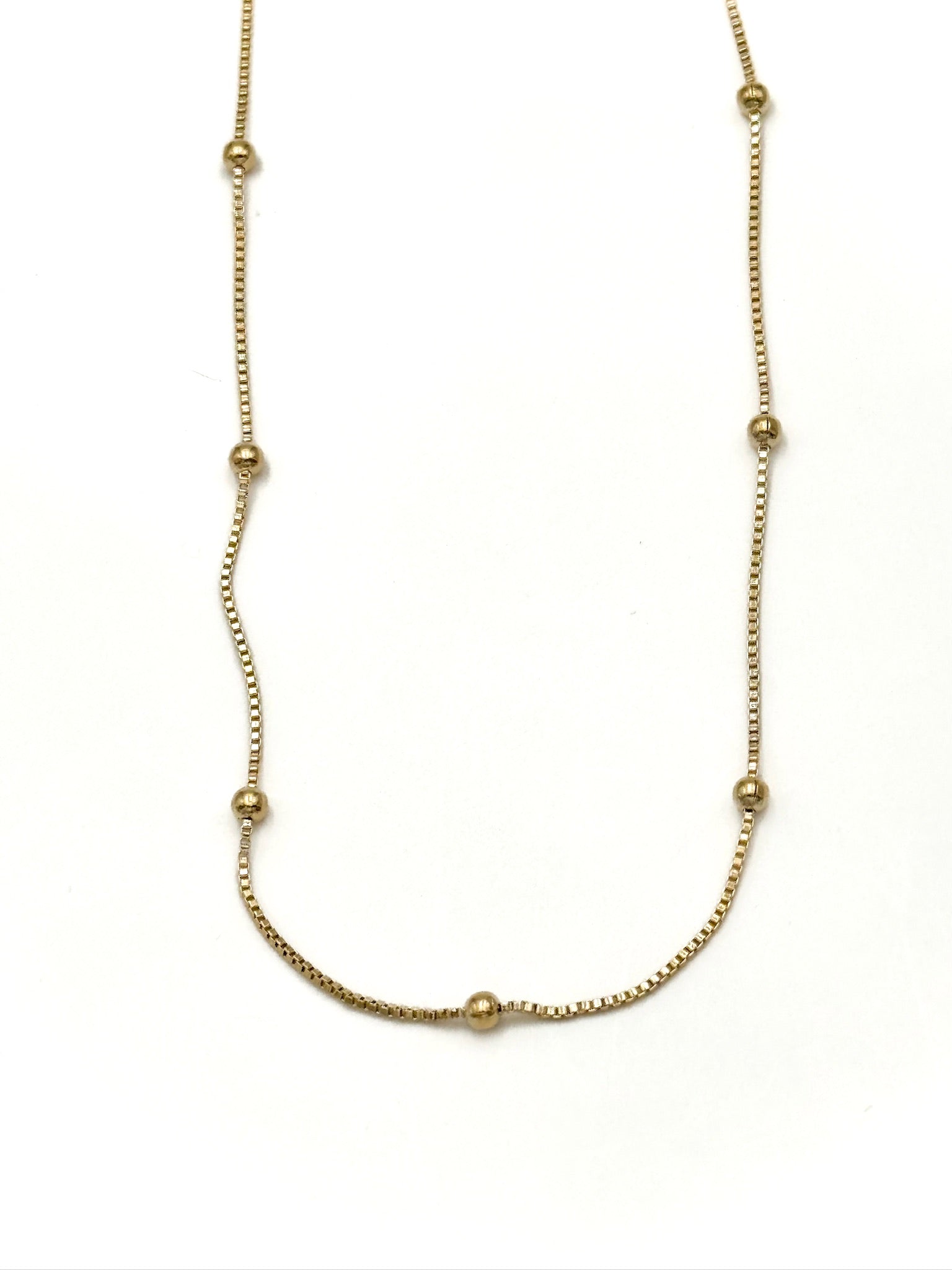 Gold necklace on a white background