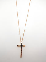 Gold-plated curved cross necklace with a delicate gold chain and slender cross pendant at Ardor Boutique.