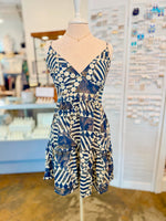Front view of the Melissa Dress in Navy featuring a geometric navy and cream print with a V necklace