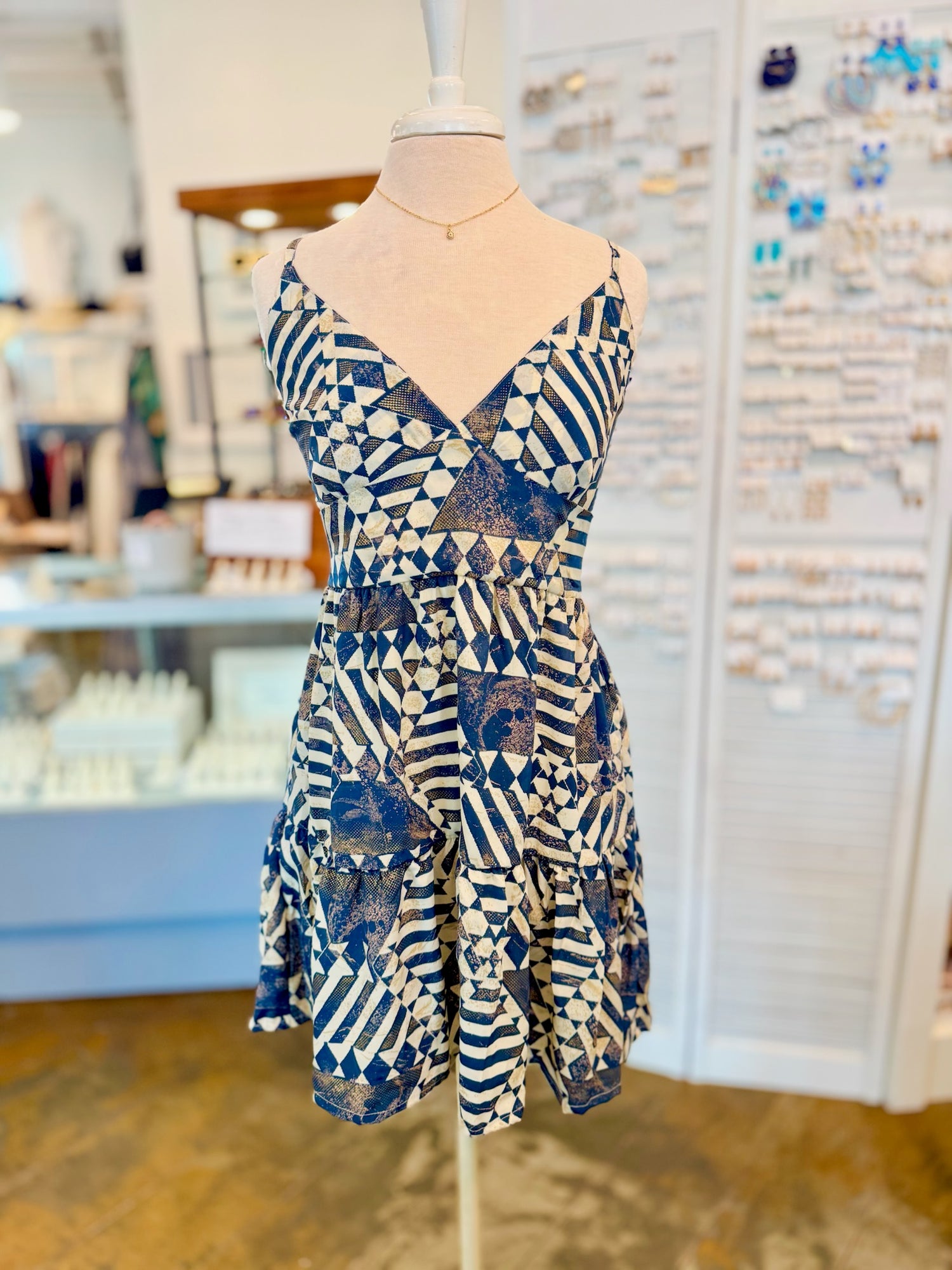 Front view of the Melissa Dress in Navy featuring a geometric navy and cream print with a V necklace