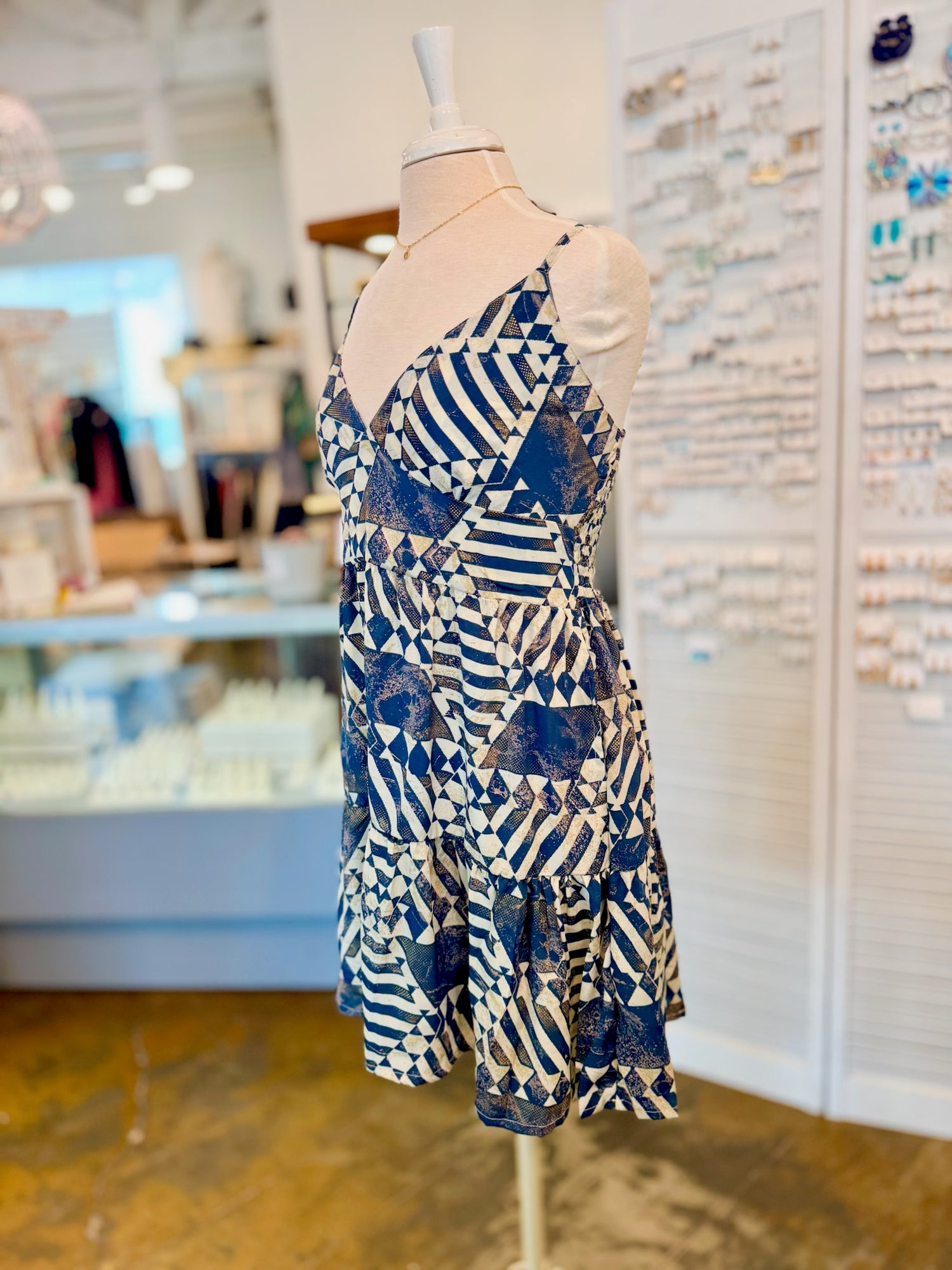 Side view of the Melissa Dress in Navy showing its lightweight tiered skirt and bold geometric pattern