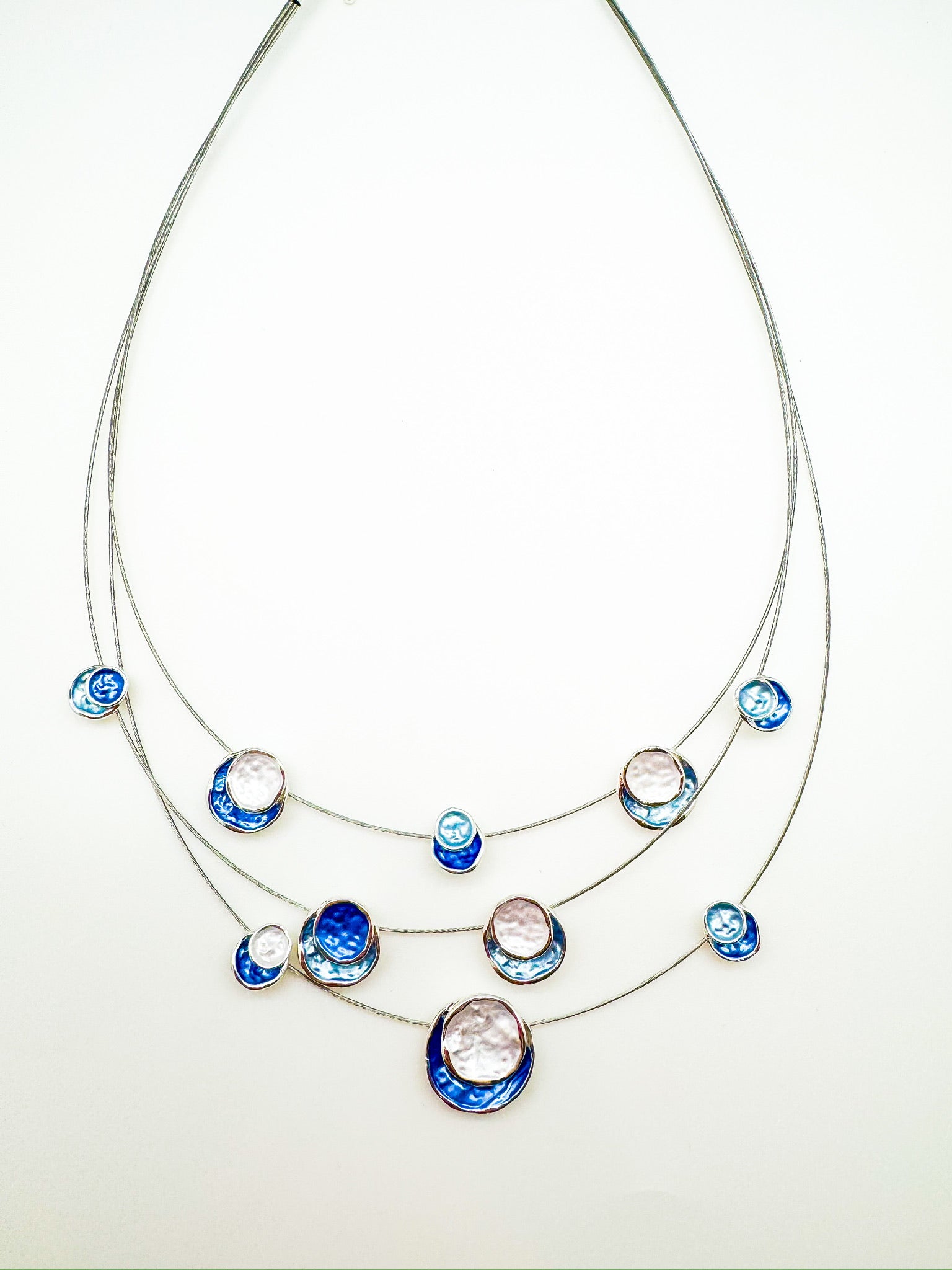 layered necklace with blue and white round discs