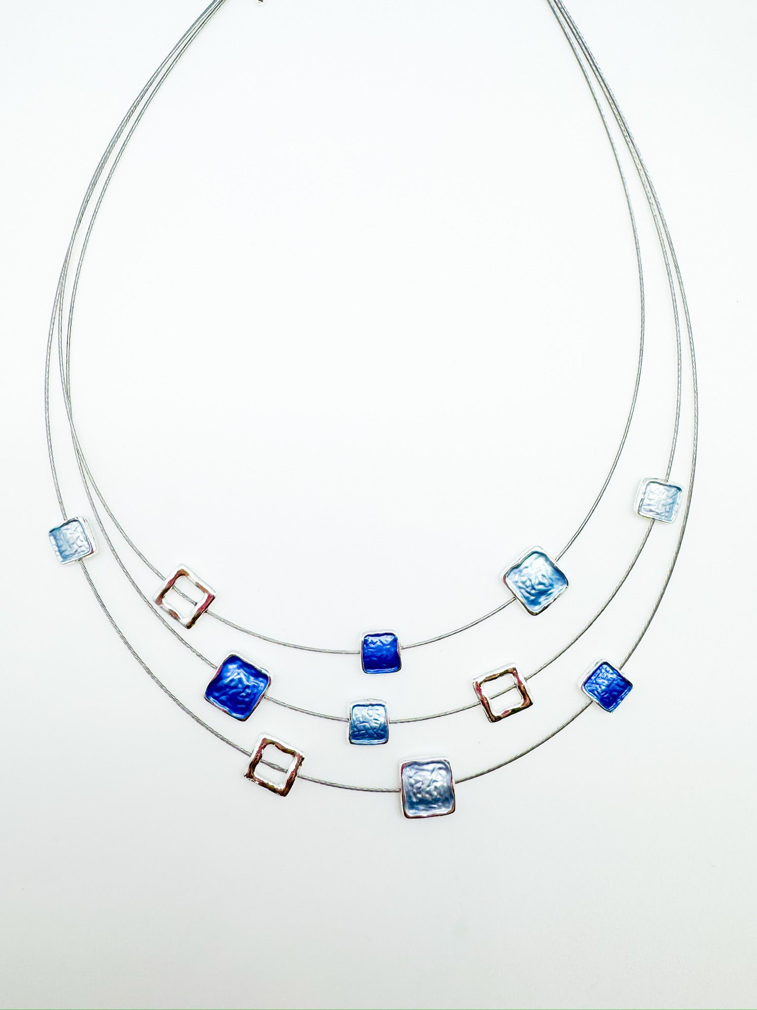 triple-layer necklace with square accents in cool blues with metallic open frames