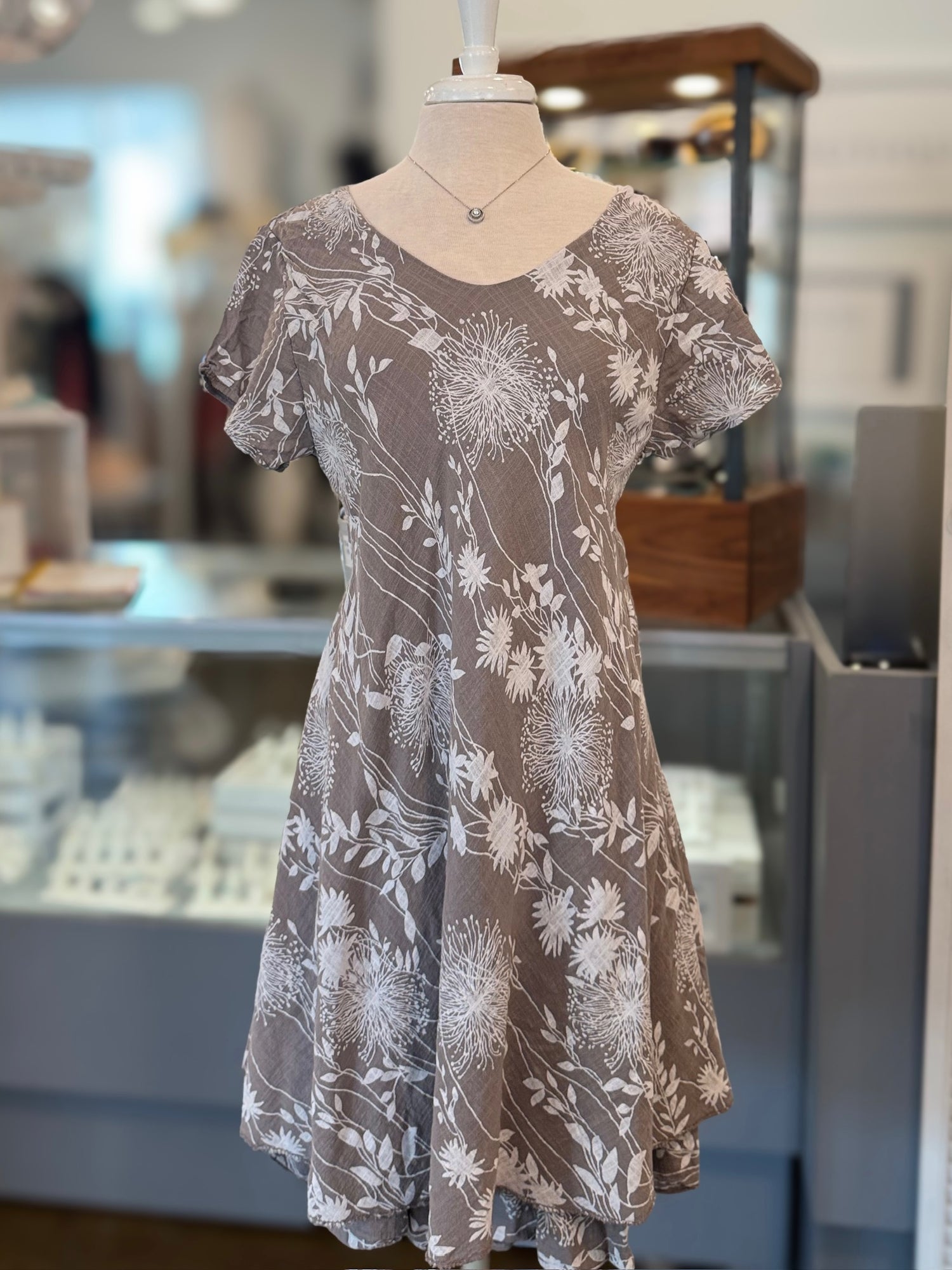 Floral dress on a mannequin in a store setting