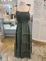 Green dress on a mannequin in a store setting