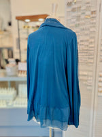 Blue cardigan on a mannequin in a store setting