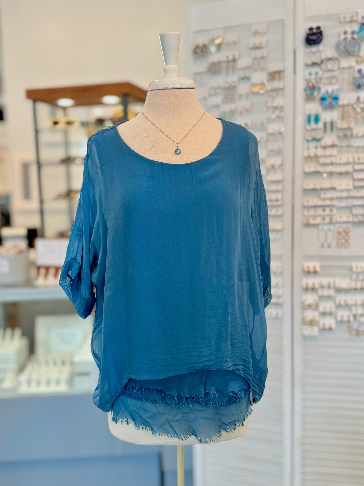 Blue top on a mannequin in a store setting