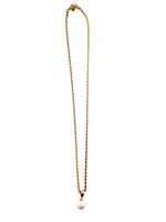 Gold chain necklace with a pearl pendant at Ardor Boutique. 