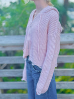 Kennedy Hoodie in blush with an open knit design, hood, ring zipper and distressed trim styled with denim at Ardor Boutique.