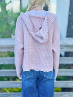 Kennedy Hoodie in blush with an open knit design, hood, ring zipper and distressed trim styled with denim at Ardor Boutique.