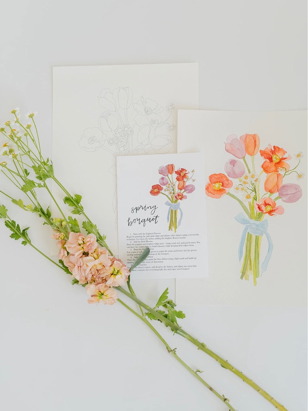 Floral arrangement with a card featuring illustrations of flowers on a light background