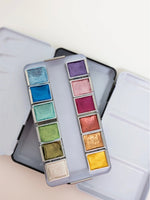 Colorful makeup palette with various shades on a light background
