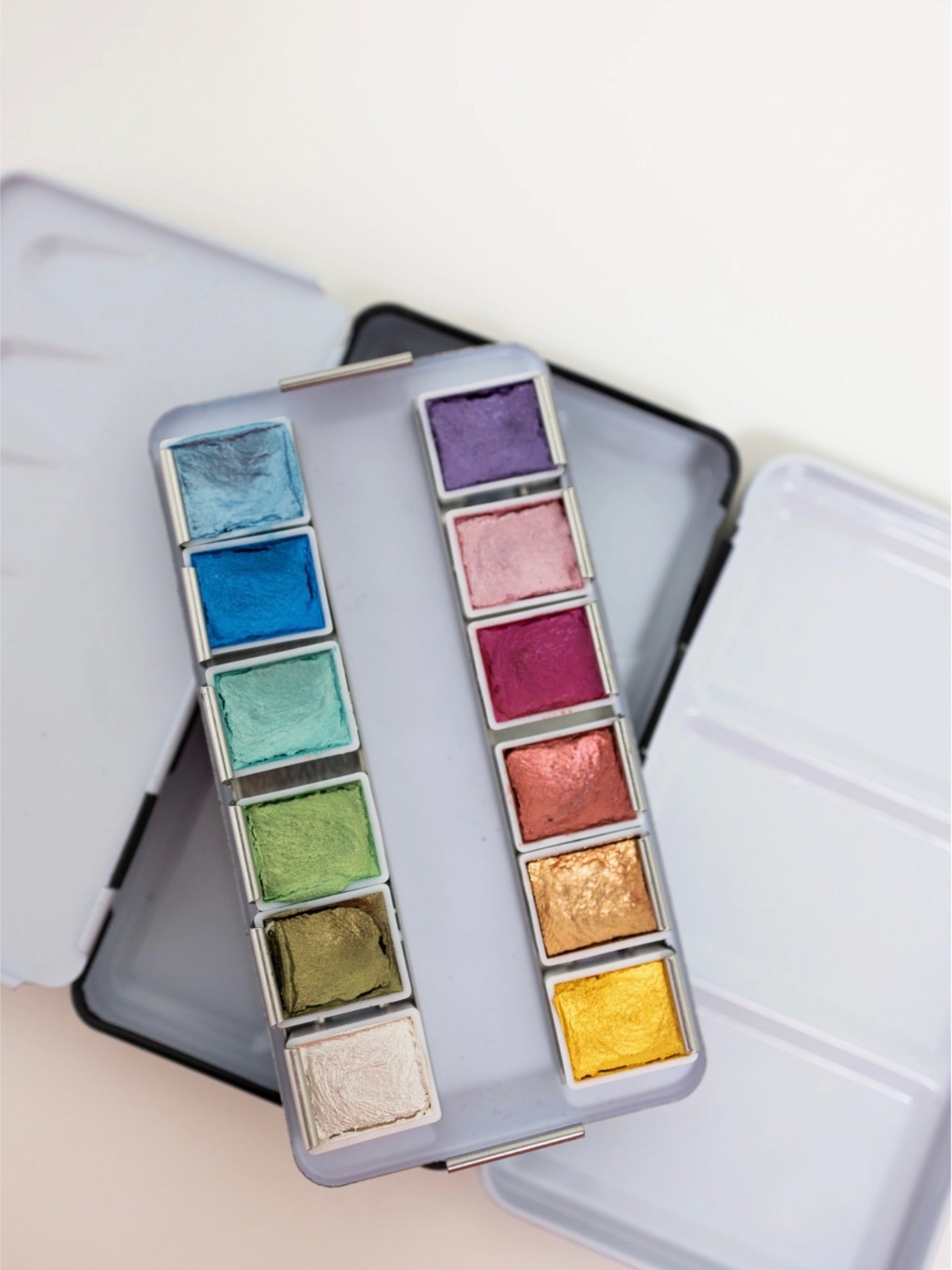 Colorful makeup palette with various shades on a light background