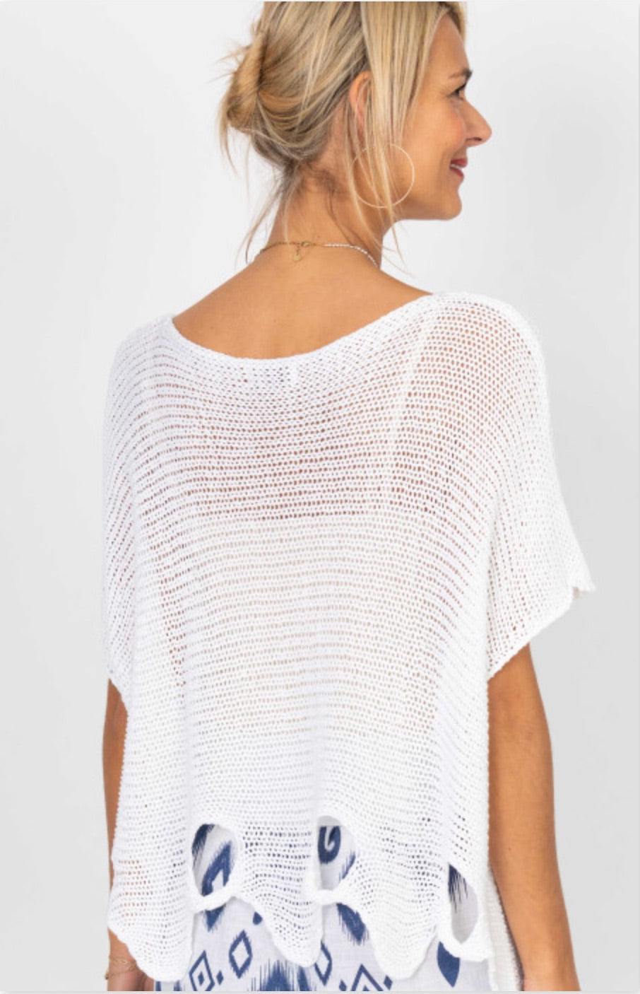 Back view of Vanda white Italian open knit sweater with airy crochet texture and relaxed draped fit