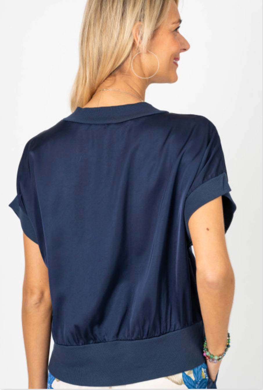 Woman wearing a navy blue blouse against a white background