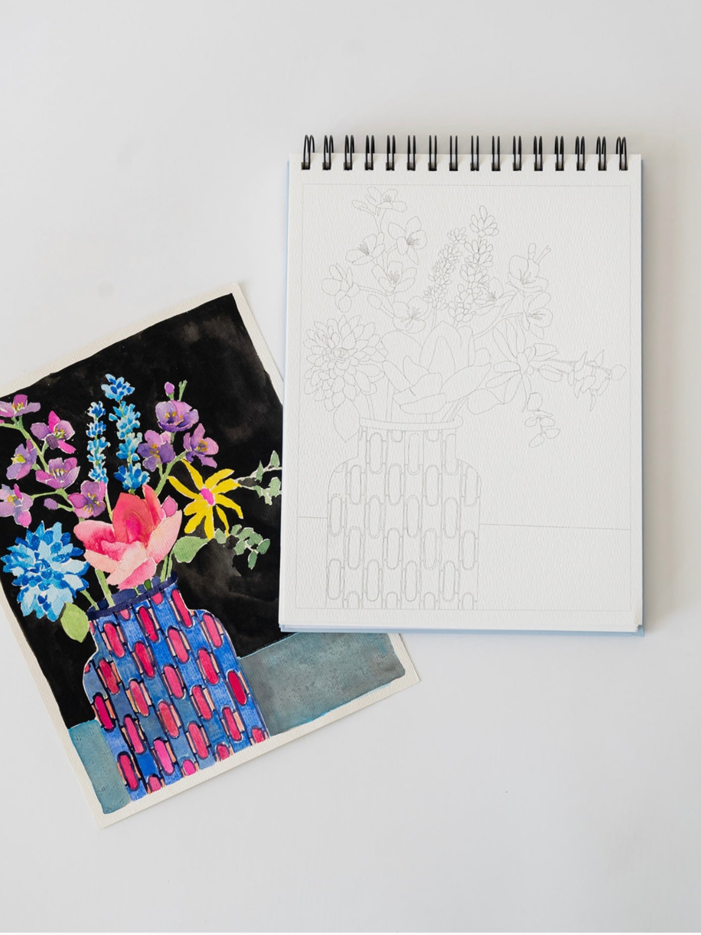 Notebook with a floral illustration on a white surface