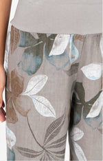 Close-up of the Catherine Linen Pants in mocha floral showing the soft knit waistband and mocha, white, and teal leaf print on linen-blend fabric.