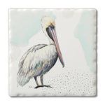 Square ceramic coaster featuring a watercolor-style pelican illustration with soft ocean background accents.
