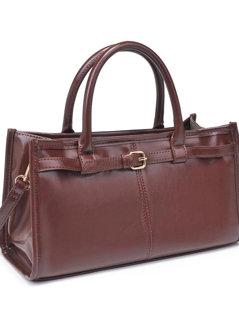 Brown leather handbag with a strap on a white background