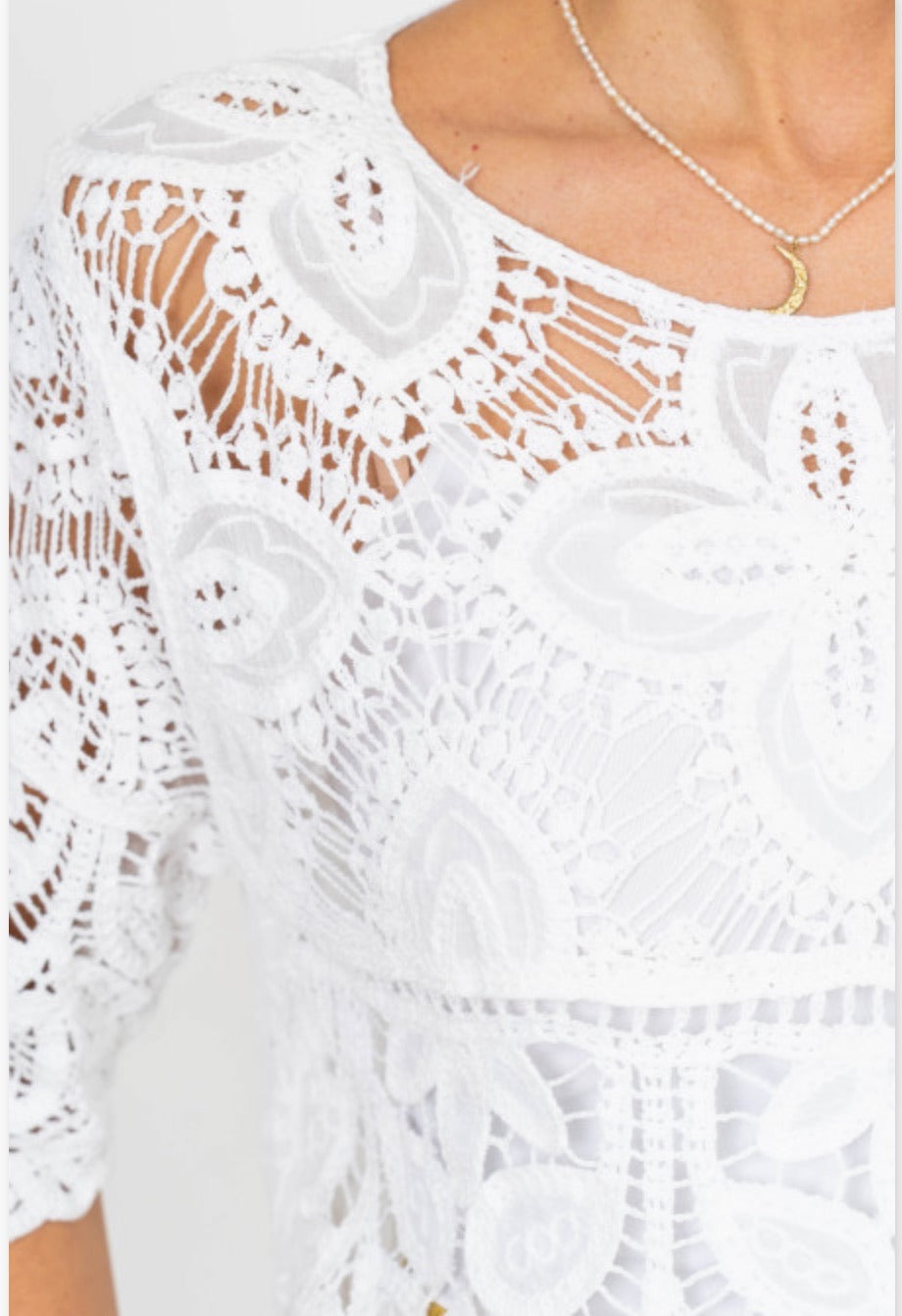 White lace top with a close-up view of the intricate design.
