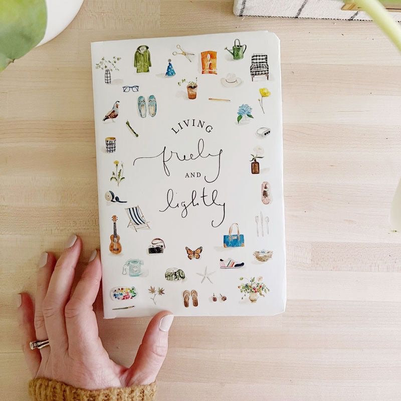 Cover of the Living Freely and Lightly Journal featuring watercolor illustrations of everyday items and handwritten script title.”