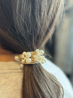 Hair tie with pearls on a person's hair