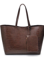 Brown crocodile-patterned handbag on a white background