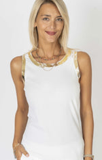 Woman wearing a white sleeveless top with gold trim. Made in Italy.