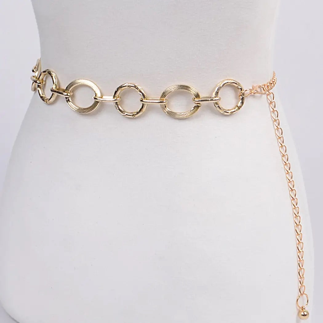 Gold circular link chain belt with smooth and textured rings styled at the waist at Ardor Boutique.