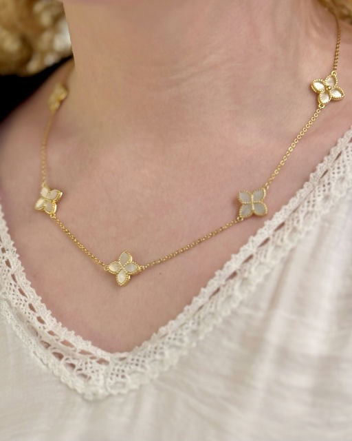 Sylvia mother of pearl gold over sterling necklace worn on neckline with floral station details