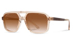 Angled view of Camp Eyewear Grateful Dead Forever sunglasses featuring a translucent champagne frame, walnut wood temples, and warm brown gradient polarized lenses.