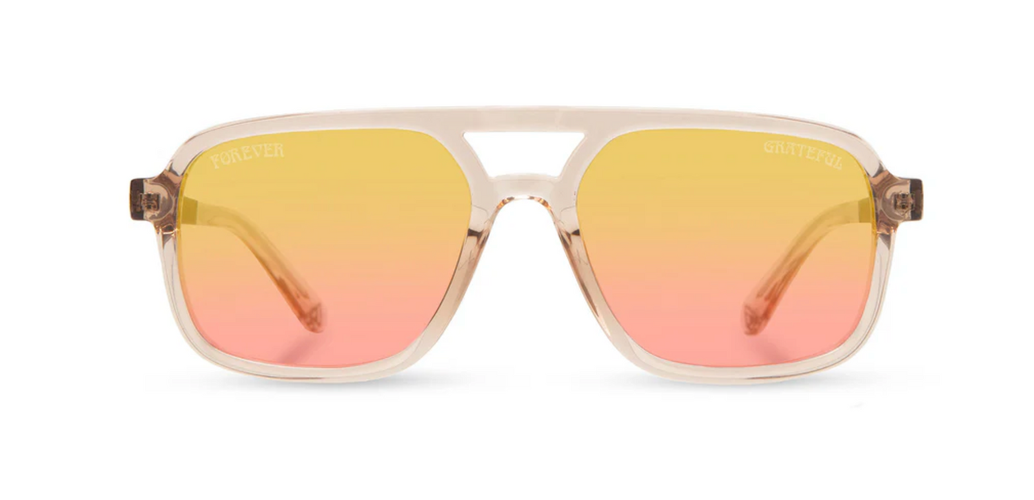 Camp Eyewear Grateful Dead Forever unisex sunglasses with a translucent champagne frame, walnut wood temples, and yellow-to-pink gradient polarized lenses.
