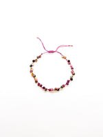 An adjustable tourmaline bracelet with a purple and green tones