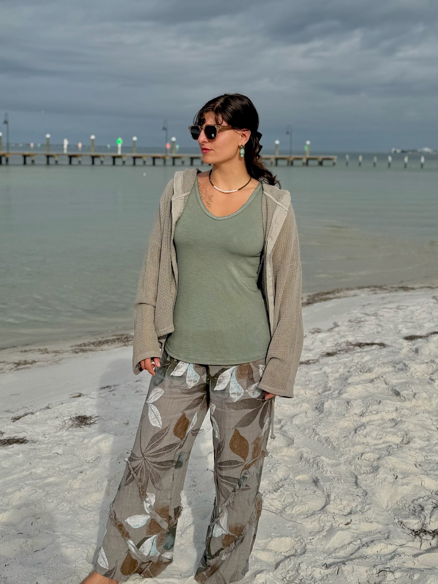 Ivy Earrings in Green shown on model with styled look: Flowy linen pants, olive tank, taupe crochet jacket, olive necklace